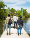 Eric Crawford and Two Other People Walking Down the Docks at Sandy Island Landing by The Athenaeum Press