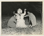 Two ladies with a snowman by Lonnie W. Fleming Sr.