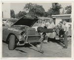 Photo of men working on a car they called "Moonlight Special by Lonnie W. Fleming Sr.