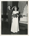 The pageant queen being crowned by a man in a suit by Lonnie W. Fleming Sr.