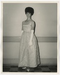 A Caucasian lady in a light colored formal dress by Lonnie W. Fleming Sr.