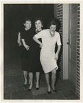 Three women smiling and lined up beside a door by Lonnie W. Fleming Sr.