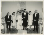 The bride and groom with their families on both sides by Lonnie W. Fleming Sr.