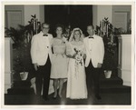 Bride and groom standing in the front of church with the bride's parents to her side by Lonnie W. Fleming Sr.