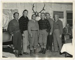 Men standing together at a hunting lodge by Lonnie W. Fleming Sr.