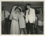 A lady whispering something to the bride by Lonnie W. Fleming Sr.