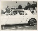 Bride and groom leaving their reception in their white Mustang by Lonnie W. Fleming Sr.