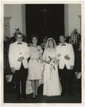 Bride and groom with a man and woman standing beside the bride by Lonnie W. Fleming Sr.