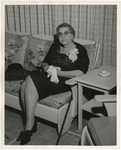 Photo of an old lady sitting on a sofa in a black dress and black shoes by Lonnie W. Fleming Sr.