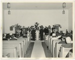 Photo of a bride and groom at the front of the church standing on a white sheet by Lonnie W. Fleming Sr.