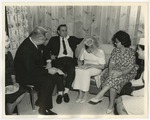 Photo of a couple signing their marriage license while sitting on a sofa by Lonnie W. Fleming Sr.