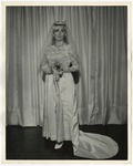 Photo of a bride wearing a long white wedding dress with see through lace at the top by Lonnie W. Fleming Sr.