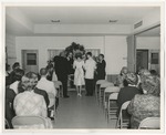 Photo of a bride and groom standing at the front of a room facing a minister by Lonnie W. Fleming Sr.