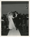 Photo of a bride and groom walking down the isle of the church to leave their ceremony by Lonnie W. Fleming Sr.