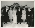 Photo of a bride and groom with their family members at their sides by Lonnie W. Fleming Sr.