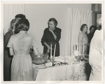 Photo of a woman eating and socializing with others by Lonnie W. Fleming Sr.