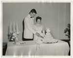 A groom and bride cutting their wedding cake by Lonnie W. Fleming Sr.