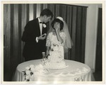 Bride and groom looking at each other eating cake by Lonnie W. Fleming Sr.