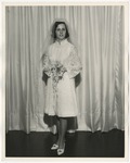 Photo of a woman in her white lacy wedding dress that ends at her knees by Lonnie W. Fleming Sr.