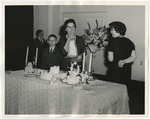 Photo of a lady eating a piece of wedding cake at the food table by Lonnie W. Fleming Sr.