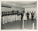 The bride, groom, and the wedding party standing along the wall in the reception room by Lonnie W. Fleming Sr.