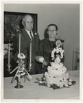 An elderly couple cutting their 50th wedding anniversary cake by Lonnie W. Fleming Sr.