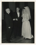 Photo of a man handing the groom a paper by Lonnie W. Fleming Sr.