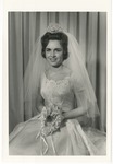 Photo of a bride in her wedding gown in front of a curtain backdrop by Lonnie W. Fleming Sr.