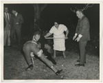 Photo of males wrestling with the groom, who is wearing a chain around his neck by Lonnie W. Fleming Sr.