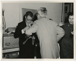 Photo of a man cutting the chain from around the groom's neck by Lonnie W. Fleming Sr.
