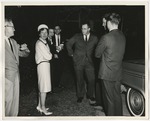Photo of the bride, wearing a dress suit with black trim by Lonnie W. Fleming Sr.