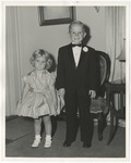 Photo of a young girl (left) in a white dress and a boy (right) in a black tuxedo and bow tie by Lonnie W. Fleming Sr.
