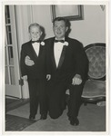 Photo of a young boy (left) in a black tuxedo and bow tie with a man (right) in a black tuxedo and bow tie by Lonnie W. Fleming Sr.