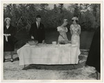 Photo of the bride, groom, and a bridesmaid at the refreshment table at Conway Riverside Club by Lonnie W. Fleming Sr.