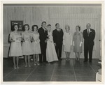Photo of the wedding party (9 people) standing against a wall at the Conway Riverside Club by Lonnie W. Fleming Sr.