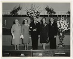 Photo of five people standing at the front of a church sanctuary in dress clothes by Lonnie W. Fleming Sr.