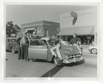 Photo of Conway High students putting something on top of a car by Lonnie W. Fleming Sr.
