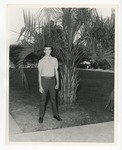 Photo of a young male standing beside a palm tree on the front lawn of Conway High School on Laurel Street by Lonnie W. Fleming Sr.
