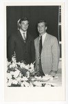 Photo of two males in suit coats standing beside each other by Lonnie W. Fleming Sr.