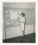 Photo of a lady teaching how to tell time in Spanish by Lonnie W. Fleming Sr.