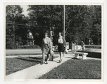Photo of three women walking on a sidewalk leading up to Conway High School on Laurel Street by Lonnie W. Fleming Sr.