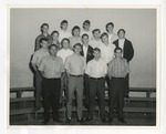 Photo of sixteen Conway High School male students grouped on three rows of bleachers by Lonnie W. Fleming Sr.