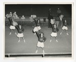 A photo of cheerleaders at a football game with their pom-poms by Lonnie W. Fleming Sr.