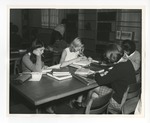 A photo of four girls sitting at the same desk and studying in the Conway High School library by Lonnie W. Fleming Sr.