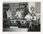 A photo of four girls and a boy reading magazines in the Conway High School library by Lonnie W. Fleming Sr.