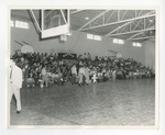 A photo of faculty and students in the bleachers of the Conway High School gymnasium by Lonnie W. Fleming Sr.