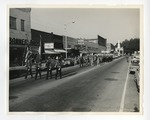 A photo of ROTC, the marching band, and the flagettes marching down Third Avenue in Conway by Lonnie W. Fleming Sr.