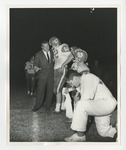 A photo of a man in a suit telling a football player something by Lonnie W. Fleming Sr.