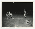 A photo of two football players tackling each other with another on the ground by Lonnie W. Fleming Sr.