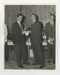 A photo of a male student accepting an award from another man by Lonnie W. Fleming Sr.